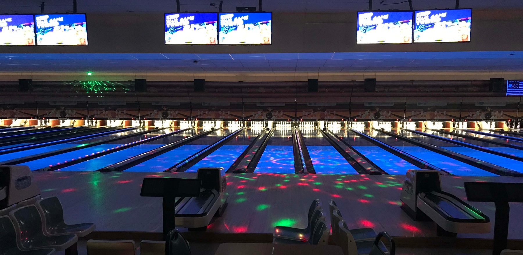 Glow bowling under colored lights during Thunder Alley at Tiki Lanes