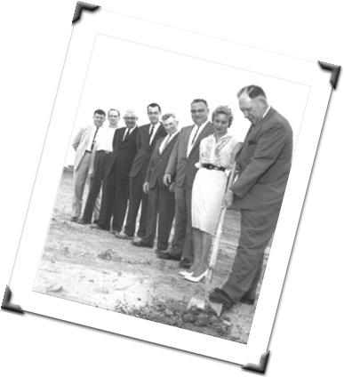 black and white photo of man diffing the first whole for construction of the bowling alley